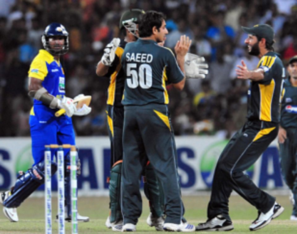 Saeed Ajmal is congratulated after getting the key wicket of Kumar Sangakkara