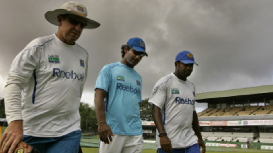 Trevor Bayliss, Kumar Sangakkara and Muttiah Muralitharan leave the ground as dark clouds loom large