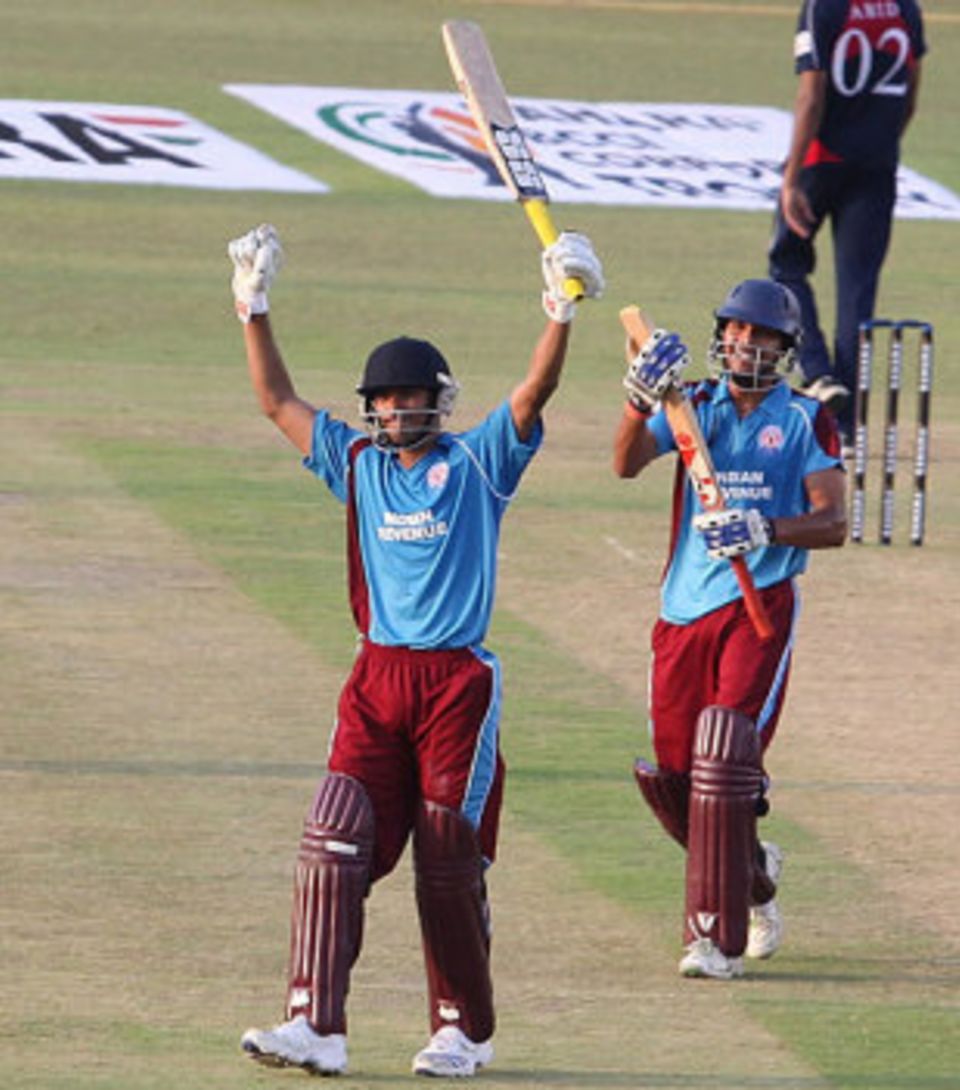 Avik Chowdhury raises the bat after reaching his century against ITC