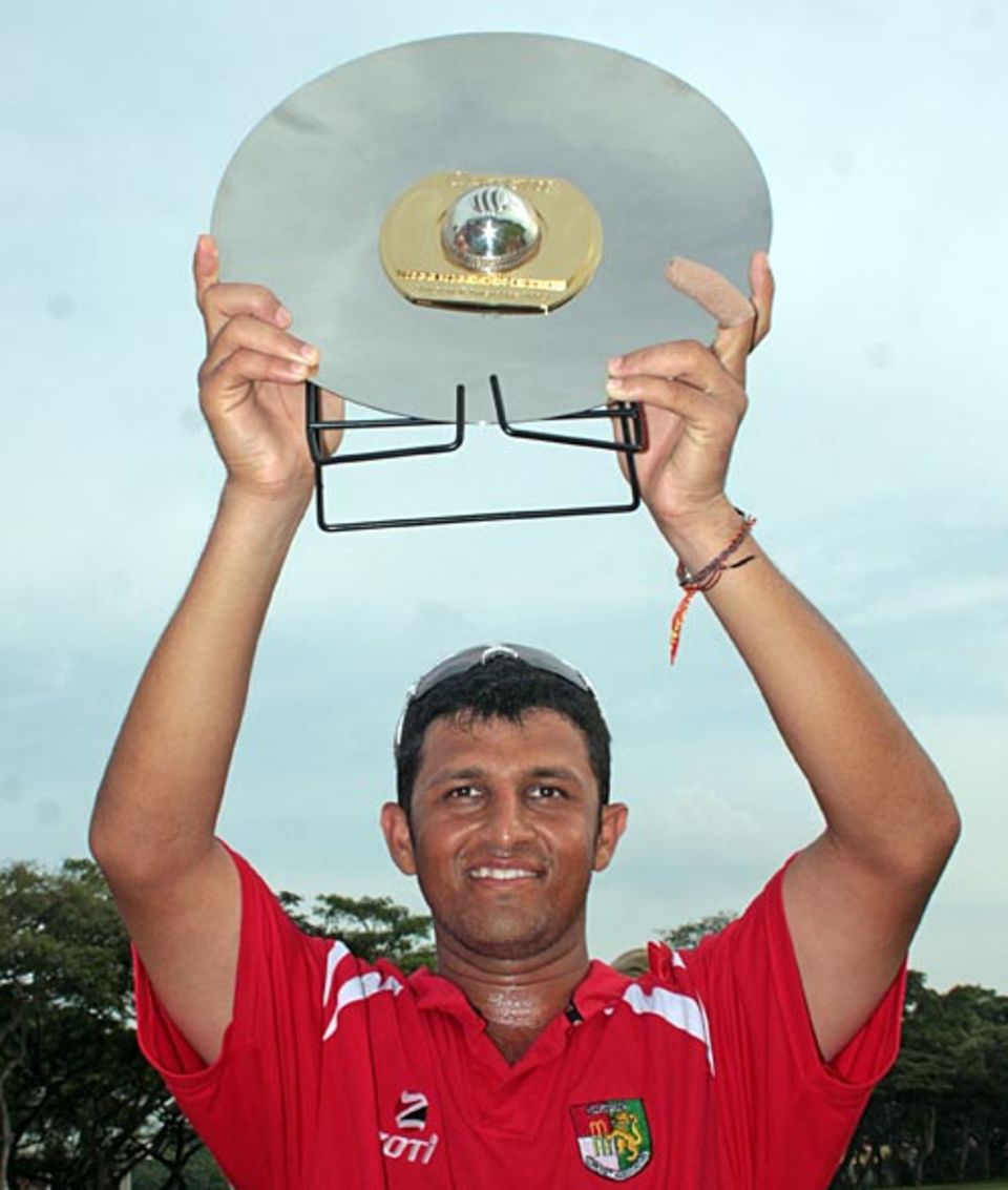 Chetan Suryawanshi, the Singapore captain, with the trophy