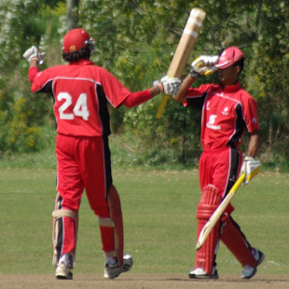 Usman Limbada (right) brings up his century