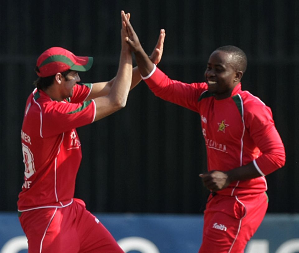 Prosper Utseya and Graeme Cremer celebrate a wicket