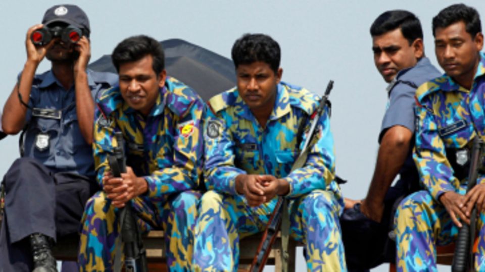 Bangladesh security personnel watch England's warm-up against Canada