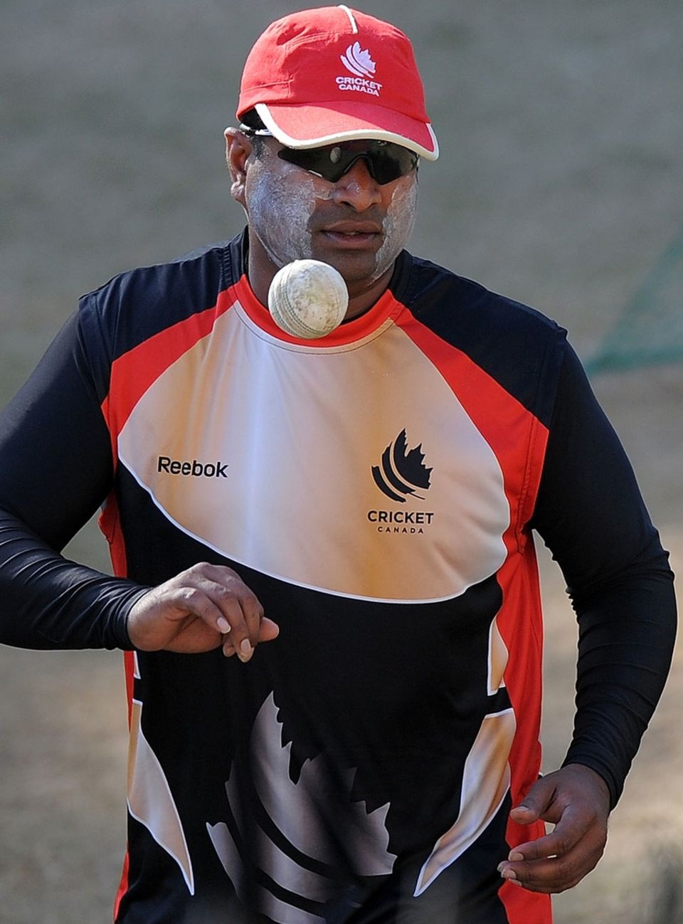 Balaji Rao prepares to bowl during practice