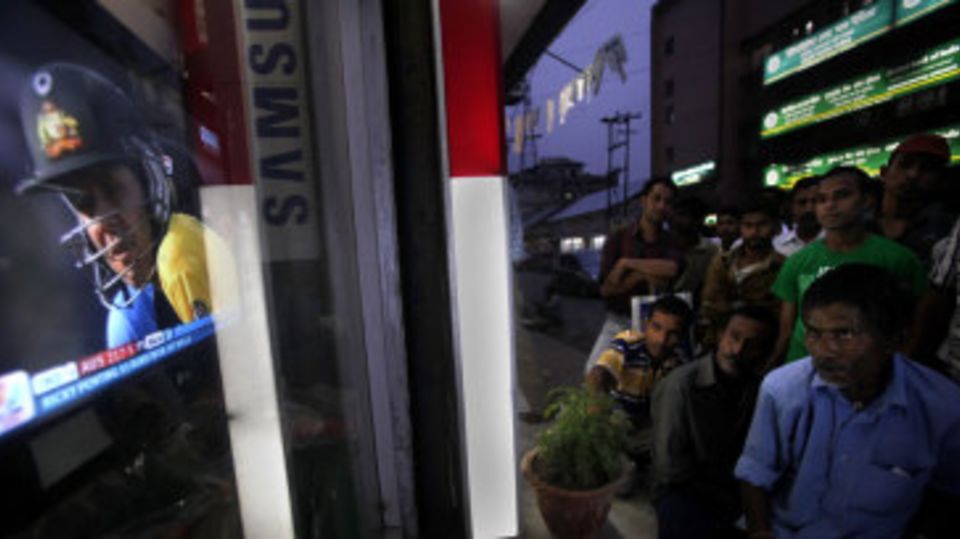 Fans in Assam watch the India-Australia quarter-final from outside a television shop