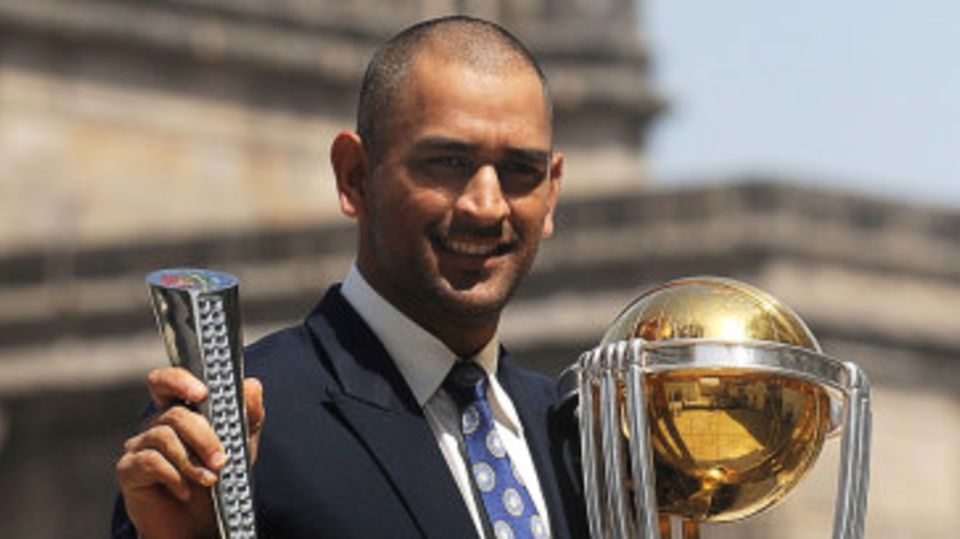 MS Dhoni with the World Cup trophy and his Man of the Match award from the final