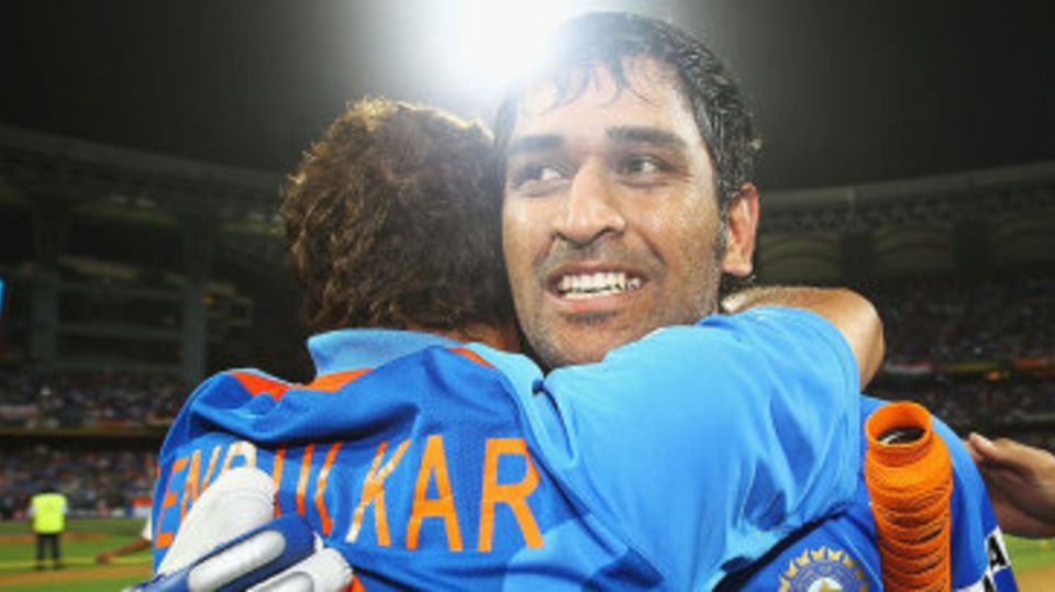 An emotional MS Dhoni is hugged by Sachin Tendulkar after India's victory