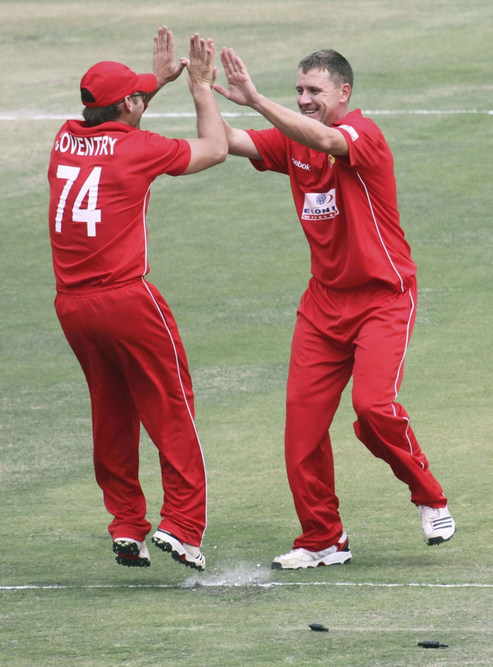 Charles Coventry gets a high five after running out Asad Shafiq