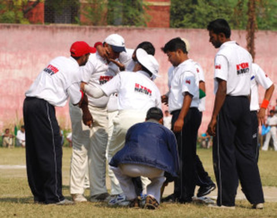 Inmates offer the Rotarian captain sympathy after he was hit in the eye against Kolkata's combined jails team in December 2010. The match inside Dum Dum correctional home attracted a "captive" crowd of 2000