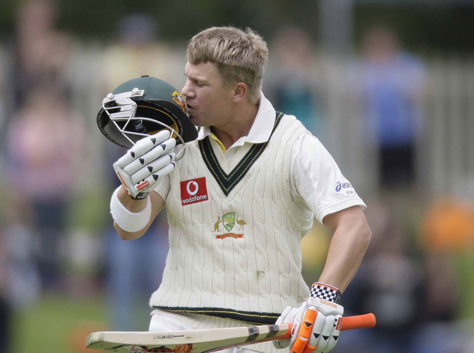 David Warner kisses the Australia logo after getting to a hundred