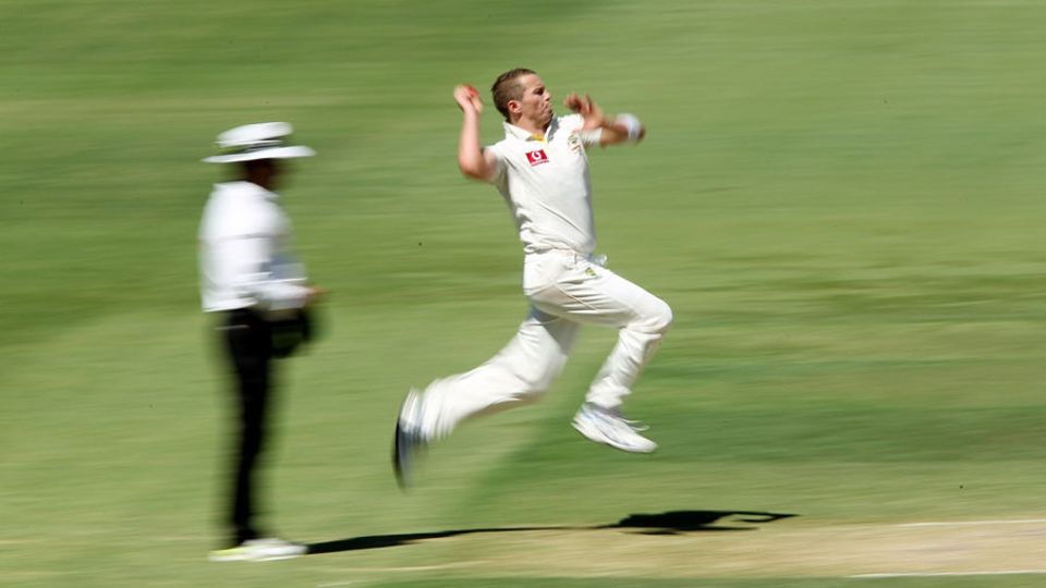Peter Siddle runs in to bowl