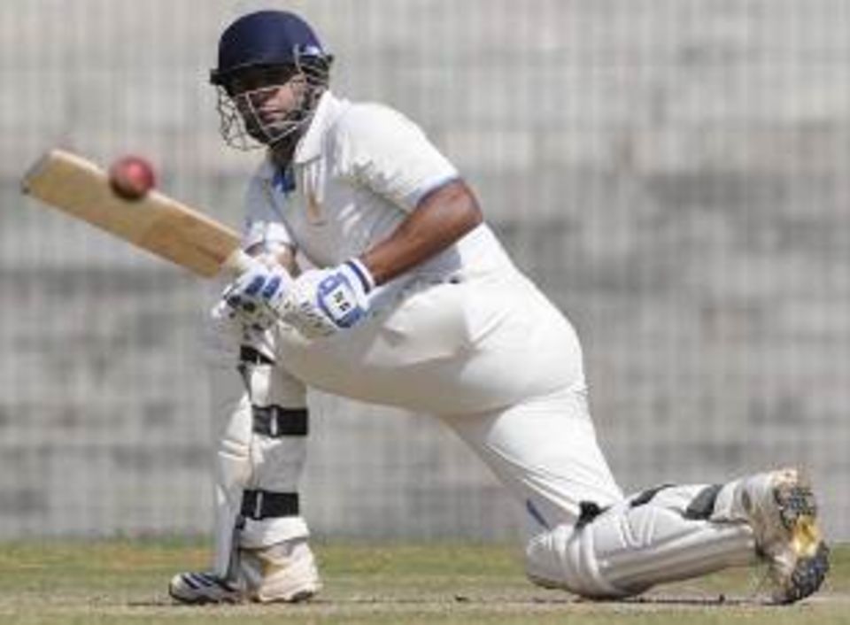 Stuart Binny sweeps during his half-century