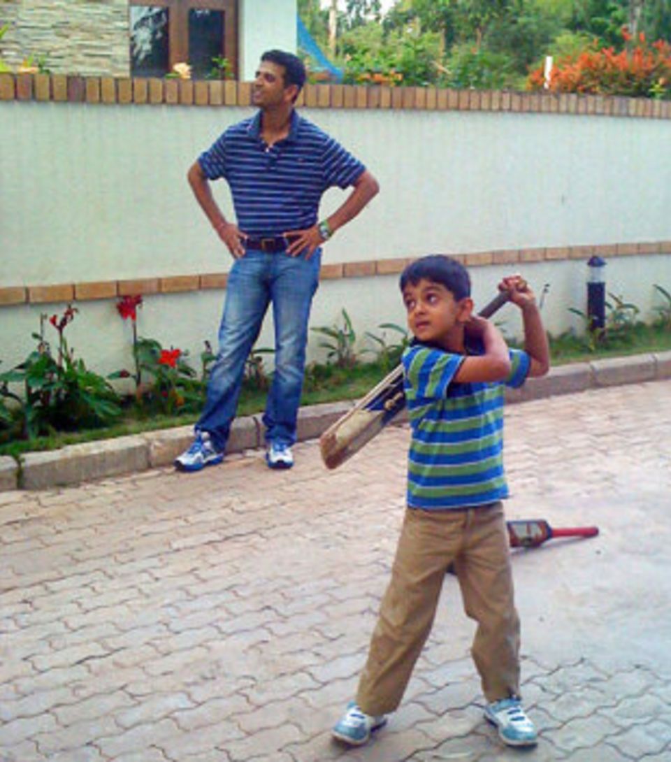 Dravid watches his son Samit play outside their home in Bangalore