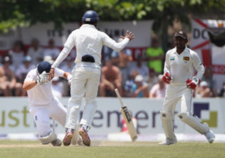 Jonathan Trott ends up in a heap after colliding with Prasanna Jayawardene having been stumped