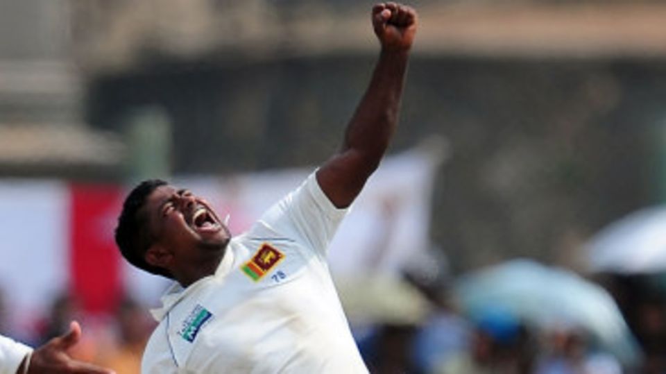 Rangana Herath celebrates his 12th wicket of the match, trapping Graeme Swann lbw