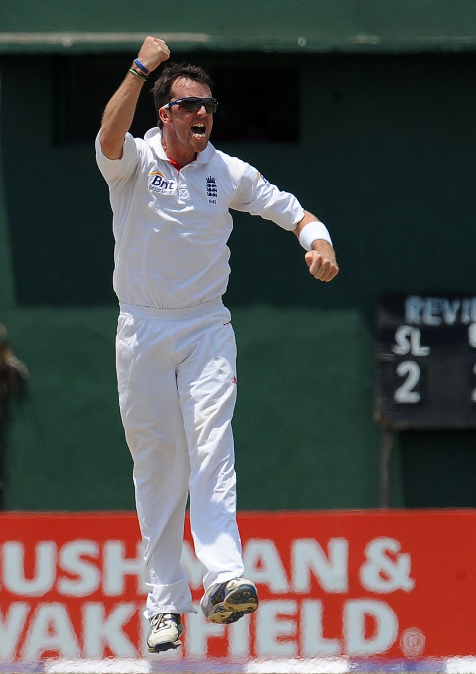 Graeme Swann jumps in the air after taking a wicket