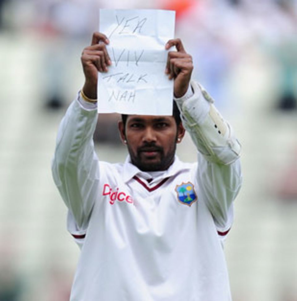 Denesh Ramdin brandishes his piece note