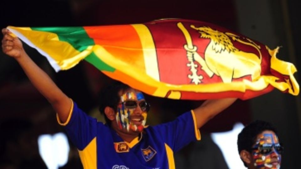 A Sri Lankan fan holds up his flag