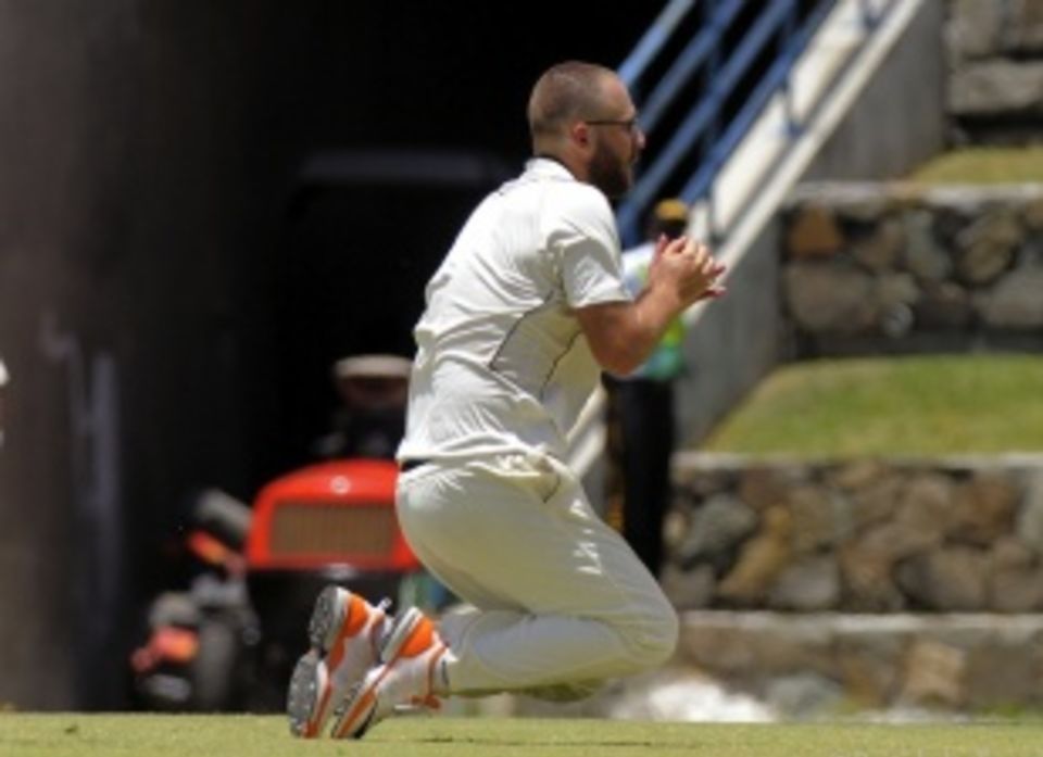 Daniel Vettori clings into a caught-and-bowled chance for his only wicket in Antigua