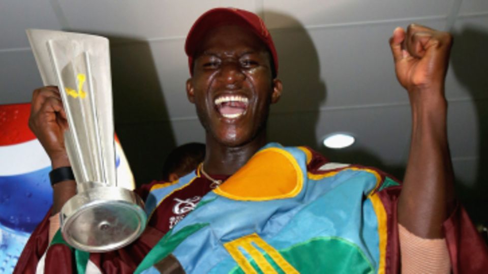 Darren Sammy with the West Indies flag and the trophy after winning the World Twenty20 title