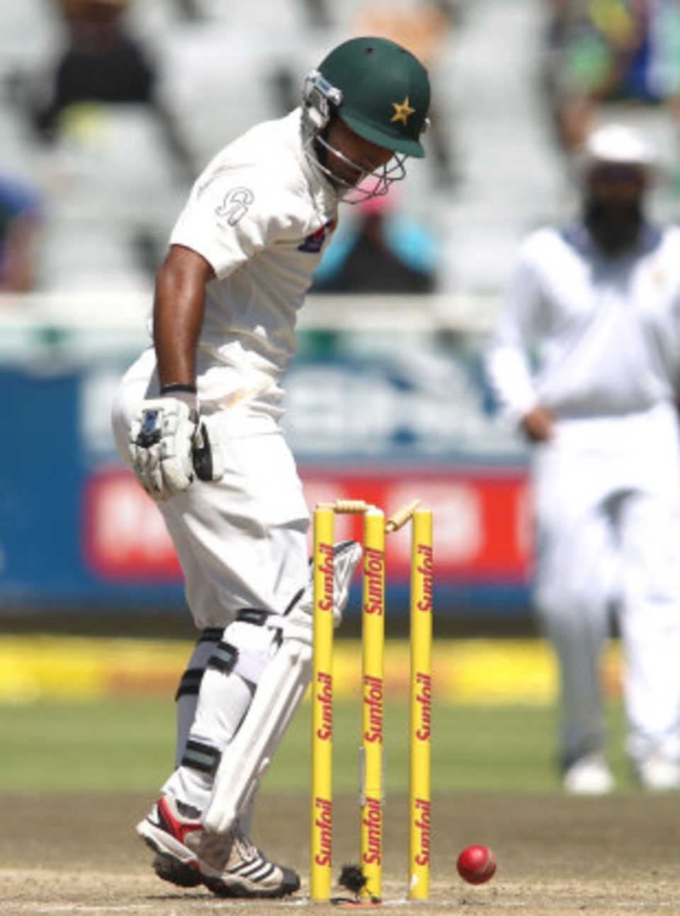 Asad Shafiq watches the ball ... on to his stumps