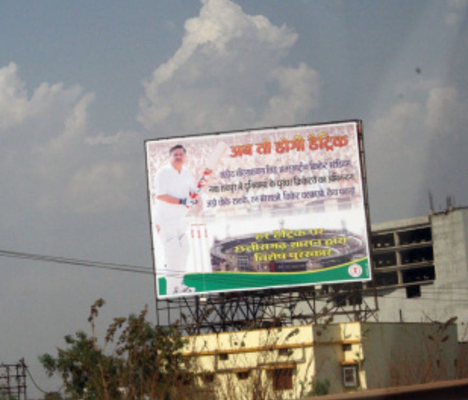 The chief minister on a billboard, in whites, to promote the matches