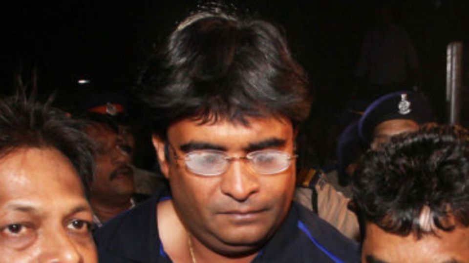 Gurunath Meiyappan is escorted after being arrested by Mumbai Police