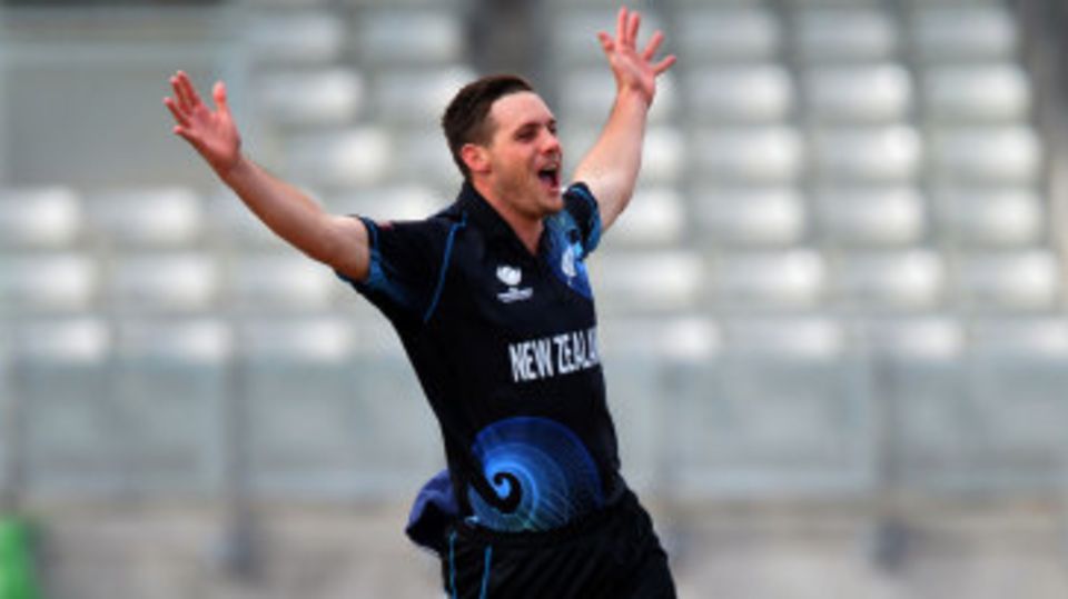 Mitchell McClenaghan's arms are aloft after taking a crucial wicket