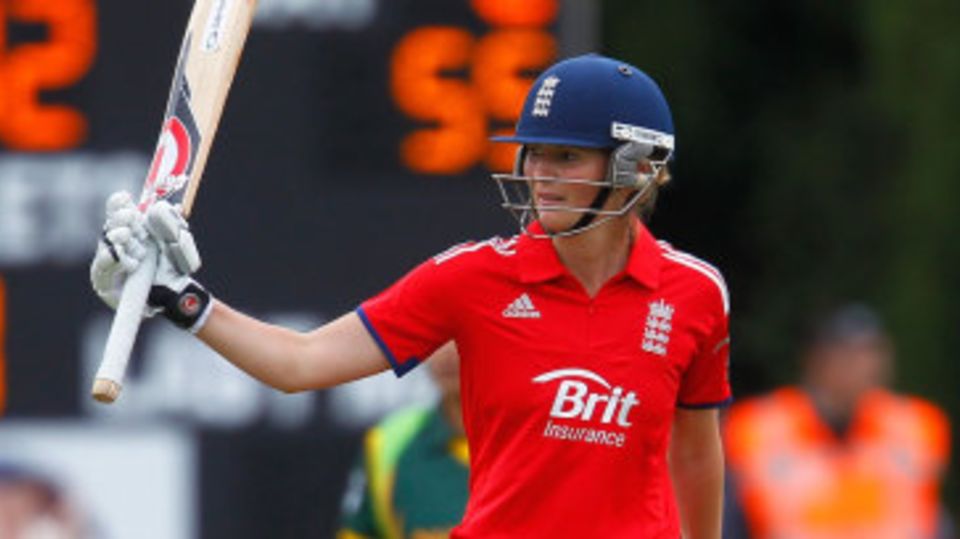 Charlotte Edwards raises her bat after reaching fifty
