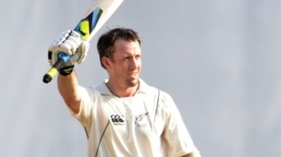 Luke Ronchi raises his bat after reaching his century