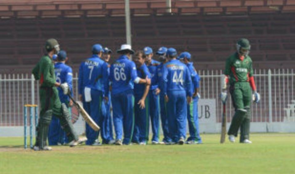 Offspinner Karim Sadiq celebrates with team-mates after taking a Kenyan wicket