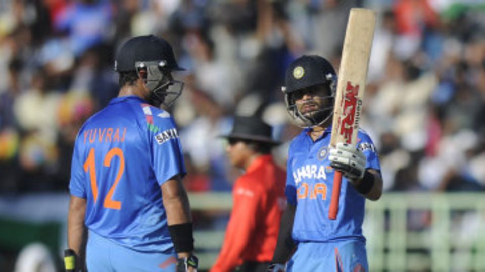 Virat Kohli raises the bat after scoring fifty