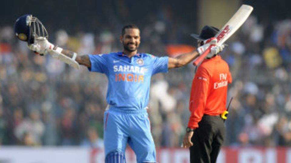 Shikhar Dhawan raises the bat after reaching his century