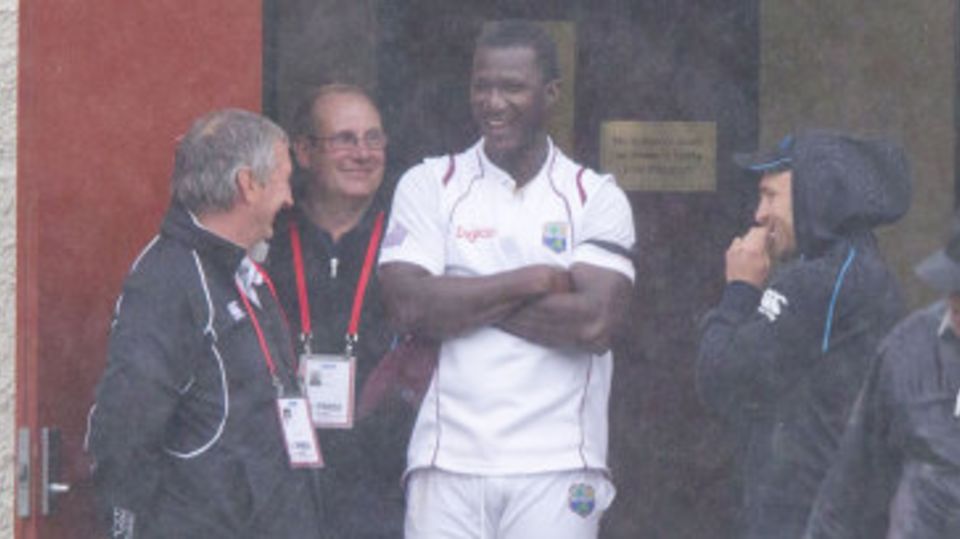 Darren Sammy takes shelter during a heavy shower