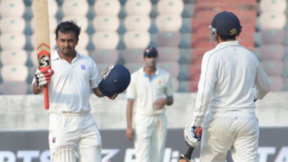 Kedar Jadhav raises his bat after scoring a hundred