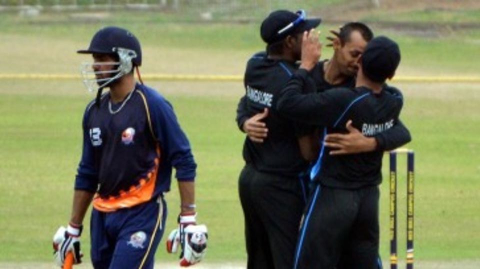 Jain University players celebrate a dismissal