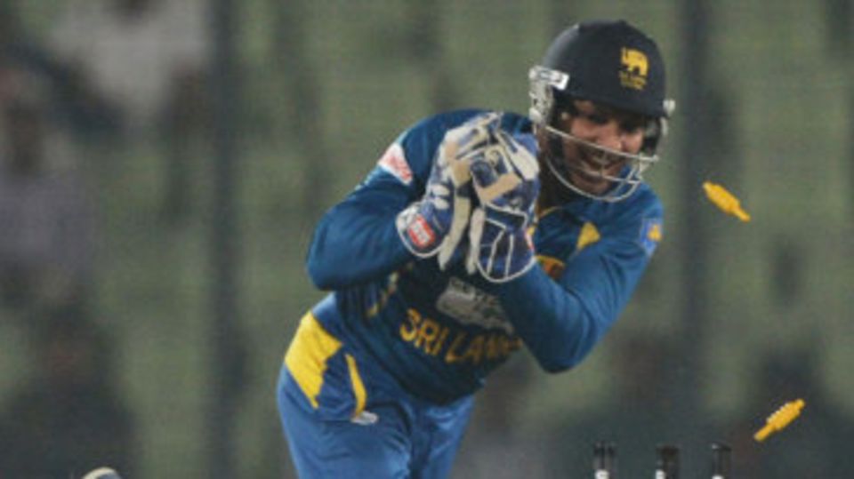 Kumar Sangakkara removes the stumps to get Shakib Al Hasan run-out