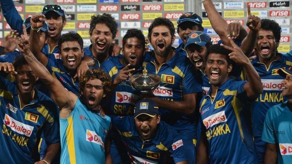 The Sri Lankan team celebrates victory after the 2014 final