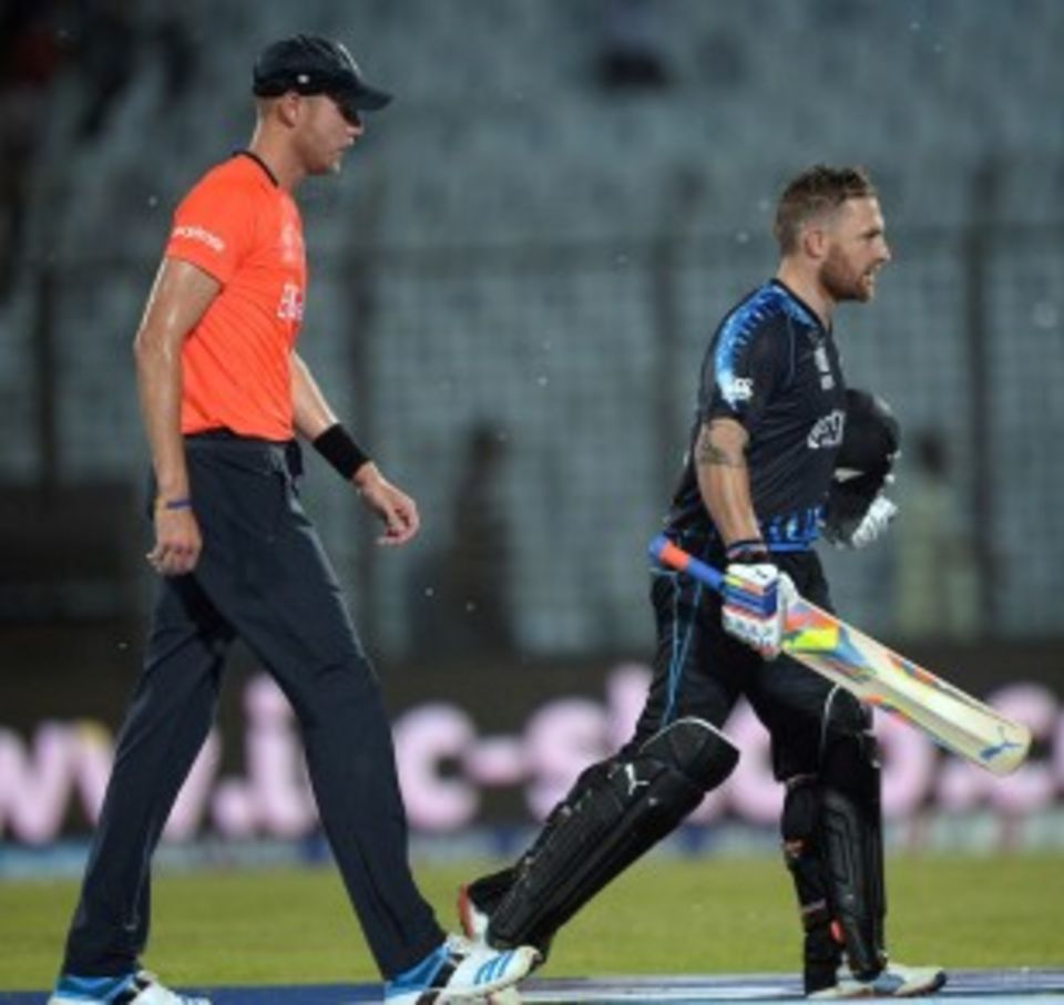 Stuart Broad and Brendon McCullum leave the field as rain hits
