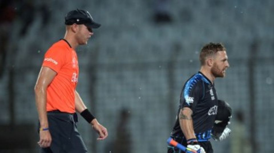 Brendon McCullum and Stuart Broad trudge off the field as it starts to pour