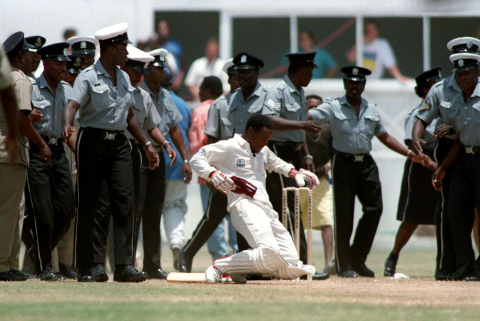 Brian Lara gets on his knees to kiss the pitch after breaking the world record in 1994