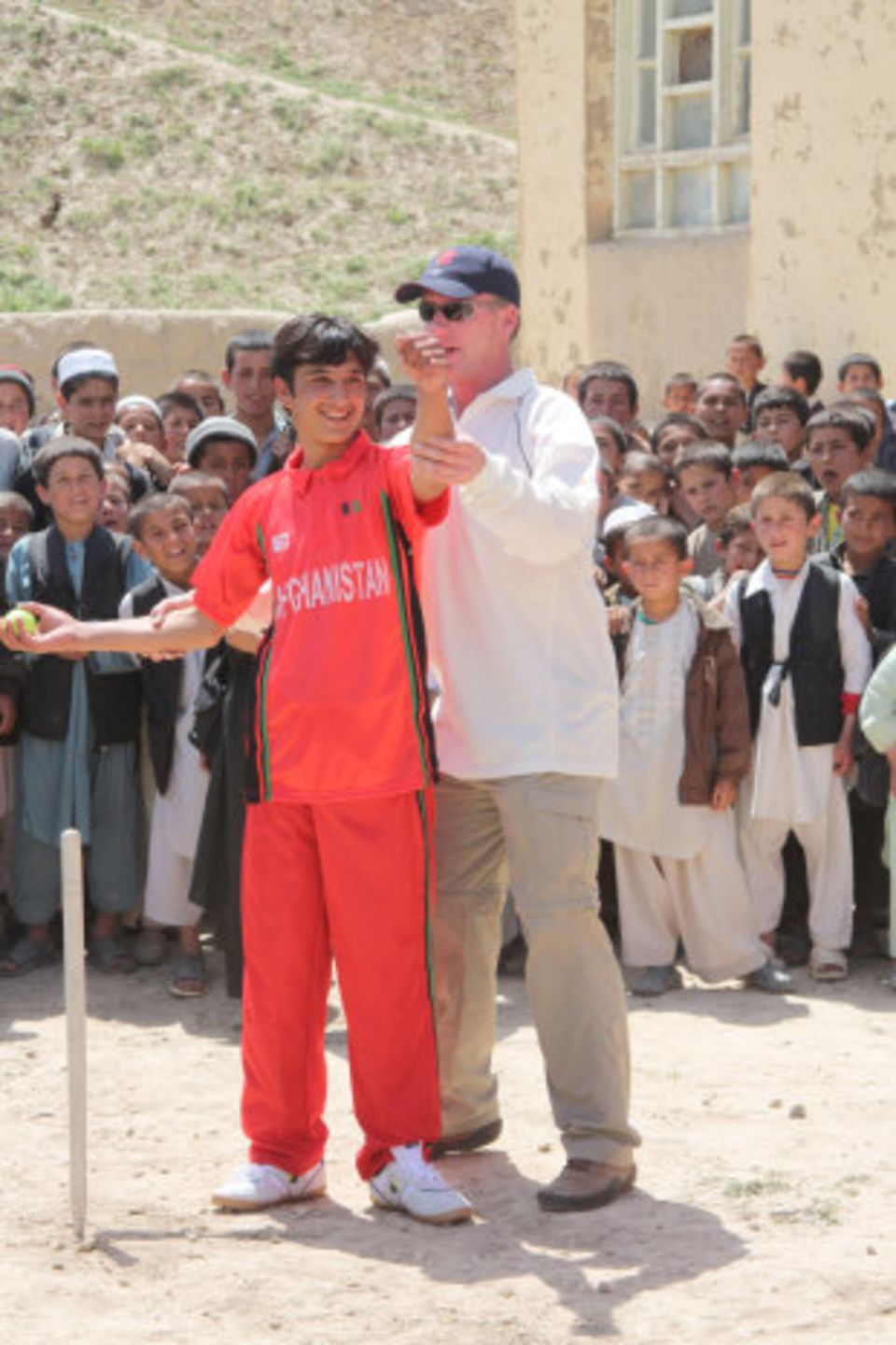 Former cricketer and MCC representative for Afghanistan Matthew Fleming works with schoolkids