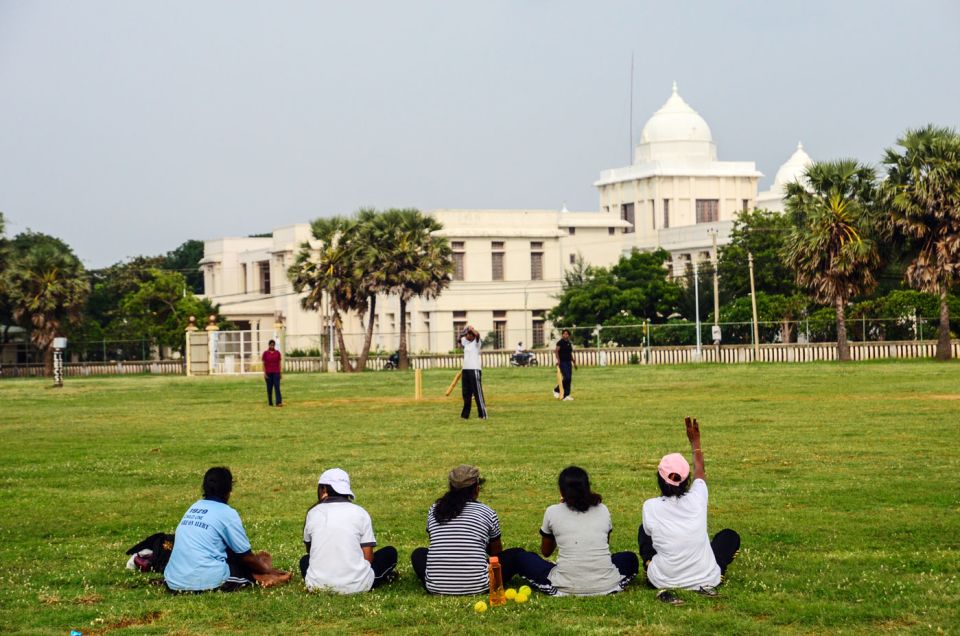 Girls play a cricket match at a ground overlooking the Jaffna library