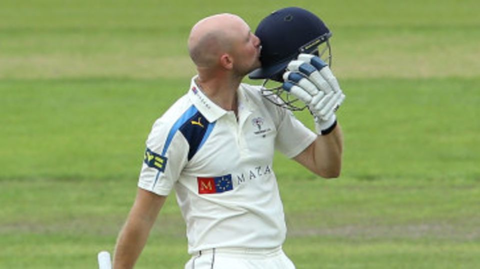 Adam Lyth kisses the badge on reaching his hundred