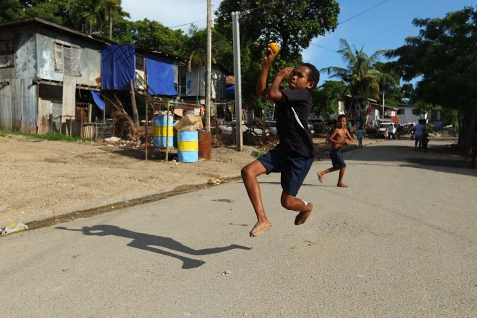 Kids play cricket on the street in Port Moresby