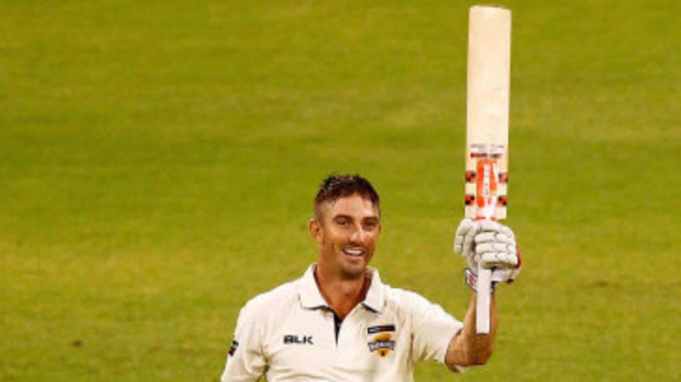 Shaun Marsh raises his bat after scoring a century