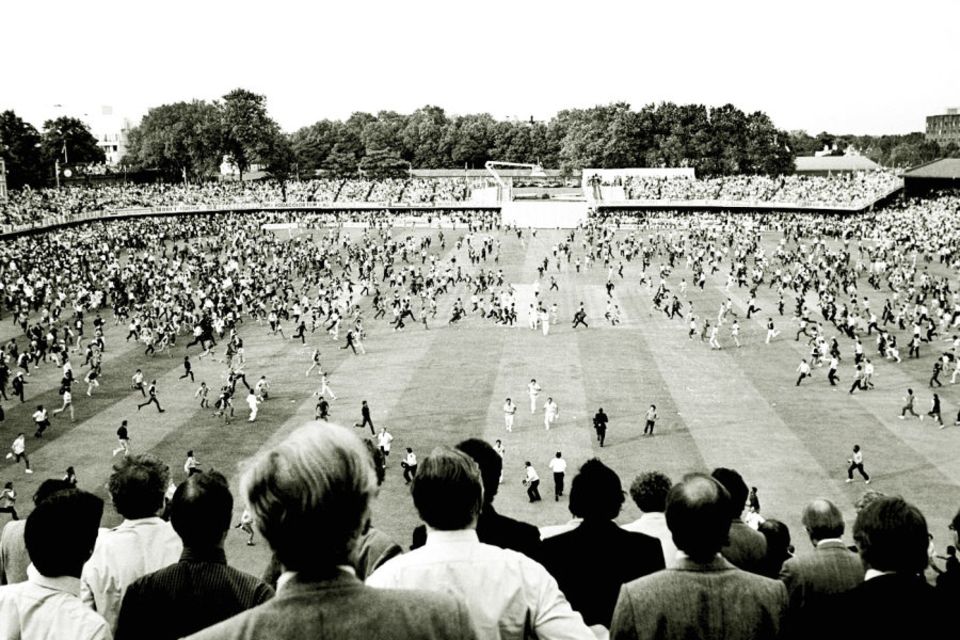 Fans swarm on to the ground after the World Cup final