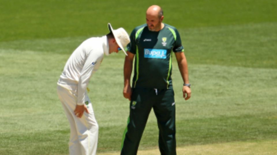 Michael Clarke speaks to physio Alex Kountouris about his hamstring