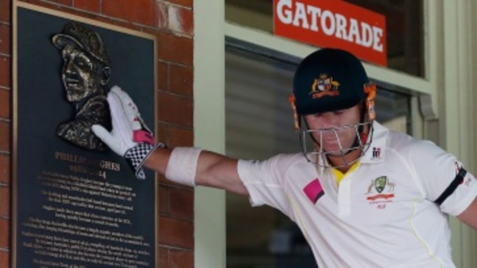 David Warner touches the memorial plaque for Phillip Hughes