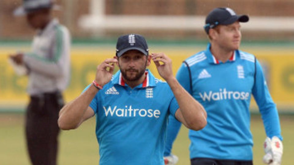 Tim Bresnan leaves the field as rain falls